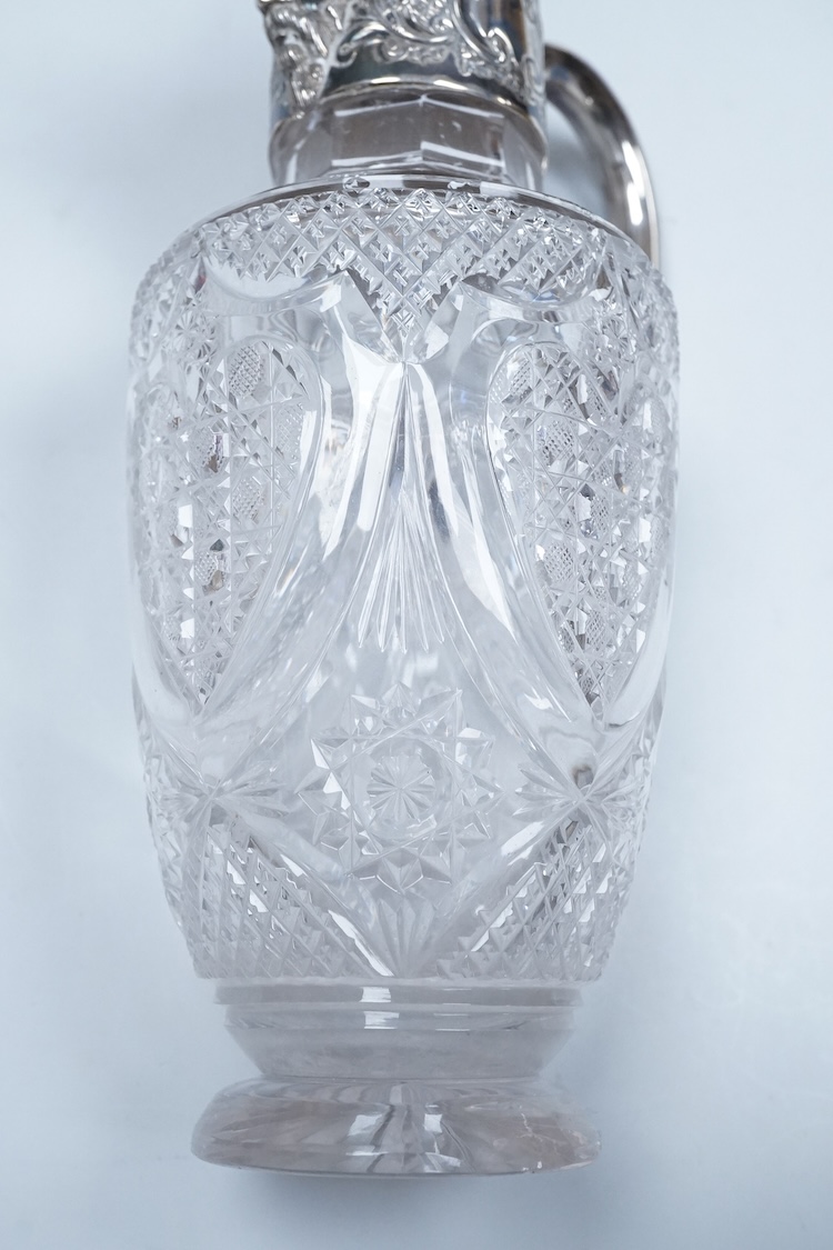 A late Victorian silver mounted cut glass claret jug, by Henry Wigfull, Sheffield, 1897, with mask spout and decorated with foliage and scrolls, height 27.5cm.